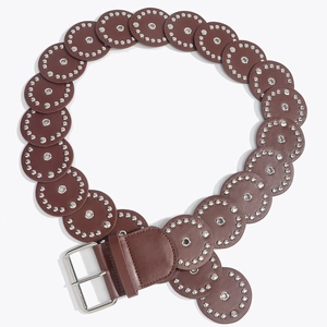 Detail of western brown leather belt with silver circular rivets and metallic buckle