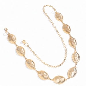 Detailed macro view of textured oval gold metal links and adjustable lobster clasp chain