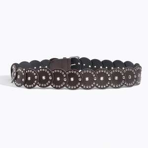 Detail of dark brown leather belt with round silver metal rivets and bohemian punk design