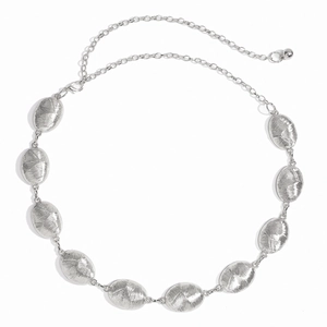 Detail view of silver oval metal chain link belt with fine brushed texture and ball charm