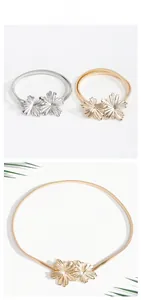 Dettaglio della fibbia floreale cinture metalliche oro e argento per abiti e cappotti