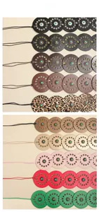 Vertical row display of colorful leather belts with turquoise rivets and bohemian metal eyelets