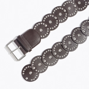 Macro detail of western brown belt with silver rivets and metal eyelets on white background