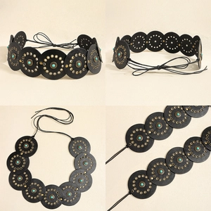 Detail of bohemian leather belt featuring round discs with turquoise beads and bronze studs