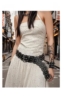 Detail of western punk style black leather belt with silver rivets and metal buckle on woman