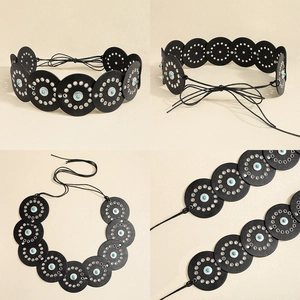 Detail of bohemian black leather disc belt with silver rivets and turquoise inlays