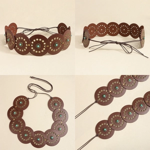 Detail of vintage brown leather belt with turquoise stone inlays and bronze eyelets