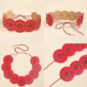 Detailed macro view of American style red leather belt with turquoise beads and studs