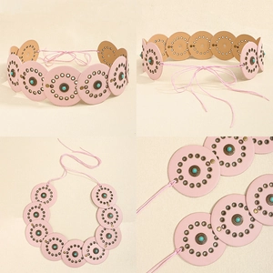 Detail of pink bohemian belt with round PU leather pieces and turquoise stone accents