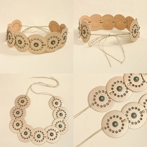 Detail of bohemian waist belt featuring turquoise studs and round faux leather cutouts