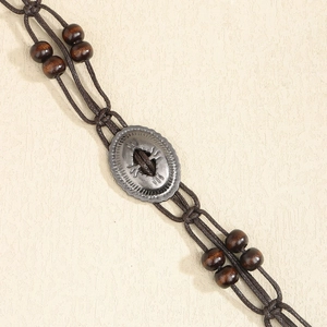 Detail showing hand-woven brown bohemian rope belt with vintage silver buckle and wood beads