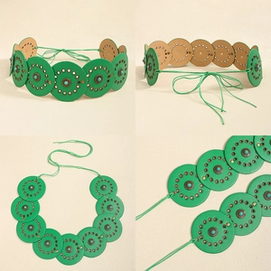 Detailed macro view of bohemian leather belt with turquoise metal discs and lace-up ties