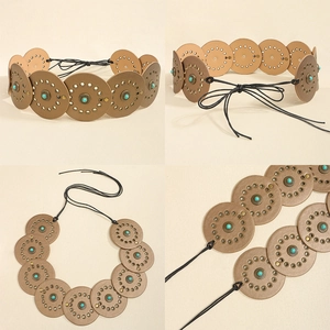 Detail of bohemian leather belt with turquoise studs and vintage metal eyelets