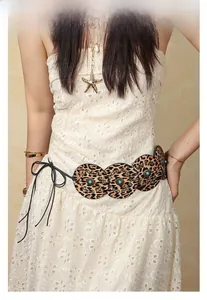 Detail of bohemian leopard print waist belt with turquoise beads and metal studs