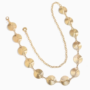 Detail of gold chain belt with spiral textured metal discs and adjustable clasp