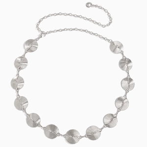 Detail of silver metal waist chain with spiral texture discs for women dresses