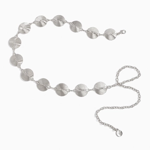 Detail of silver metal waist chain featuring round spiral textured links and lobster clasp