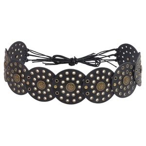 Detail of bohemian waist belt featuring black leather discs and gold metal eyelets