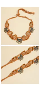 Detail of bohemian woven waist chain with turquoise beads and metallic moon charms