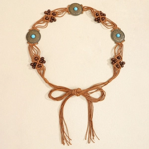 Detail of bohemian braided waist belt featuring turquoise stones and ethnic metal disks