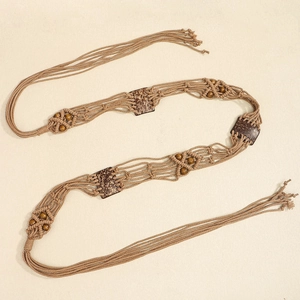Détail de la chaîne de taille bohème tressée avec perles en bois, noix de coco et franges