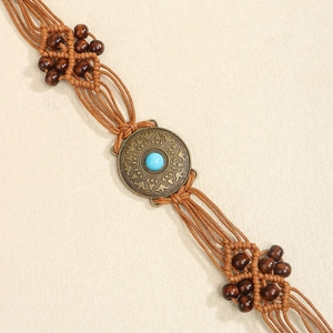 Detailed weave of Bohemian waist belt featuring turquoise inlay and wooden beads
