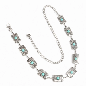 Detailed macro view of silver alloy waist chain with turquoise stones and geometric patterns