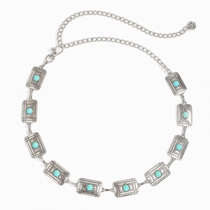 Detail view of silver metal waist chain with turquoise stones and vintage floral textures