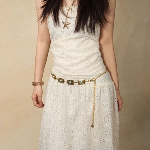 Detailed view of bohemian gold waist chain featuring turquoise inlays and elegant charms