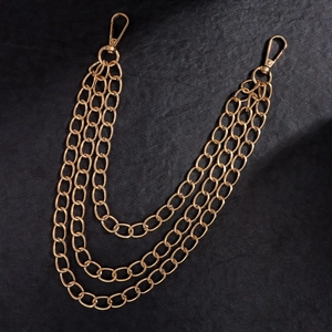 Detailed close-up of triple-layered golden punk waist chain with lobster clasps for trousers