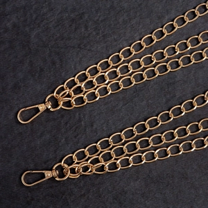 Detailed macro shot of multi-strand golden metal chains with secure lobster clasps