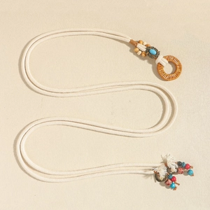 Close-up of Bohemian hand-woven waist chain with turquoise beads and colorful tassels