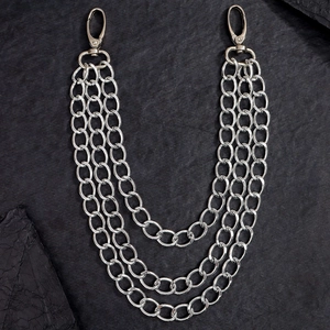 Close-up of triple-layered silver metal wallet chains with lobster clasps on stone