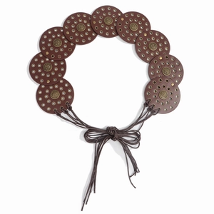 Western style brown disc belt with metal rivets and bohemian tie closure on white background