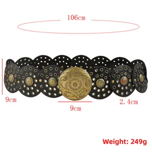 Detail view of Bohemian wide belt with vintage gold buckle and round cut-out patterns