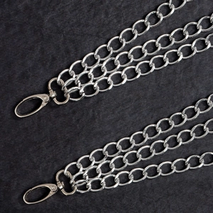 Macro detail of triple-layered silver punk metal chains with sturdy lobster clasps