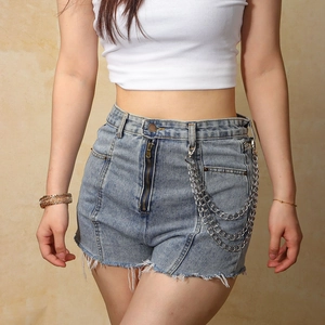 Detailed view of triple-layered metal punk style hip-hop chains on denim shorts