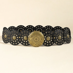 Detail of bohemian black leather waist belt with ornate golden floral buckle