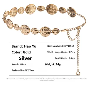 Detailed view of golden metallic waist chain with textured round plates and lobster clasp