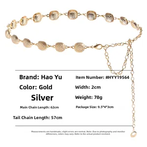 Detail view of gold metal waist chain with hammered square links and lobster clasp