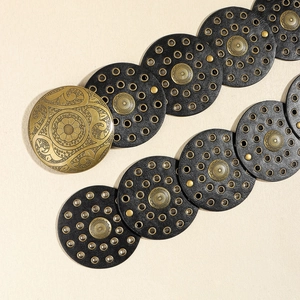 Bohemian vintage belt with black leather discs and embossed gold floral metal plates
