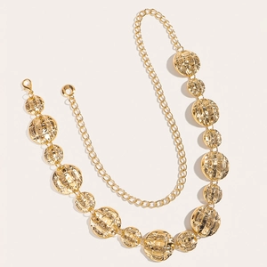 Detail view of a gold chain belt with quilted round metal plates and lobster clasp