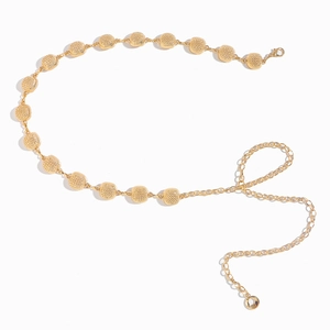 Detailed macro view of a stylish gold metal waist chain with textured circular links