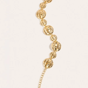 Close-up of golden quilted texture metal belt chain with adjustable length link