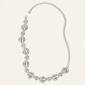Detail of silver metal waist chain featuring textured circular links and lobster clasp