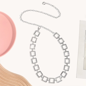 Detail of silver metal waist chain with geometric square links and adjustable ring clasp