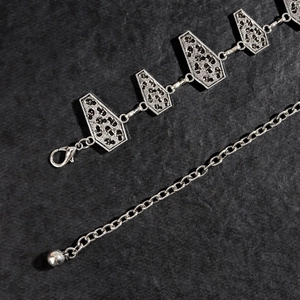 Detailed close-up of Gothic silver coffin chain belt links with leopard texture inlays