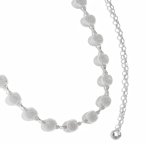 Close-up of silver metal waist chain featuring hollow circular links with mesh texture