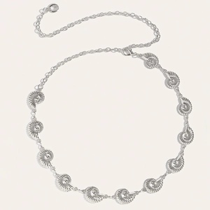 Detailed close-up of a silver conch waist chain featuring elegant sea shell ornaments