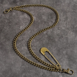 Close-up of vintage bronze cuban chain with oversized safety pin and lobster clasps